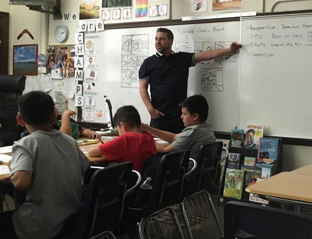  Jon Dalton presenting information to students about drawing comics